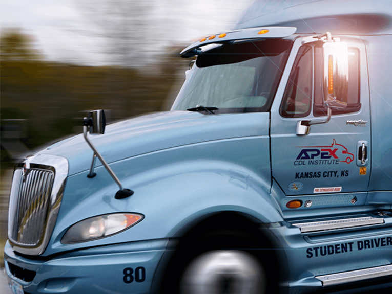 image of blue Apex truck driving, blurred to show motion