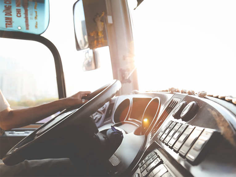 image of dashboard of truck, hands on steering wheel