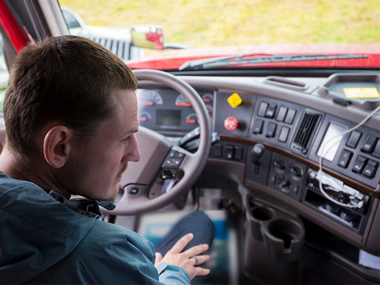 image of driver in seat looking at dashboard