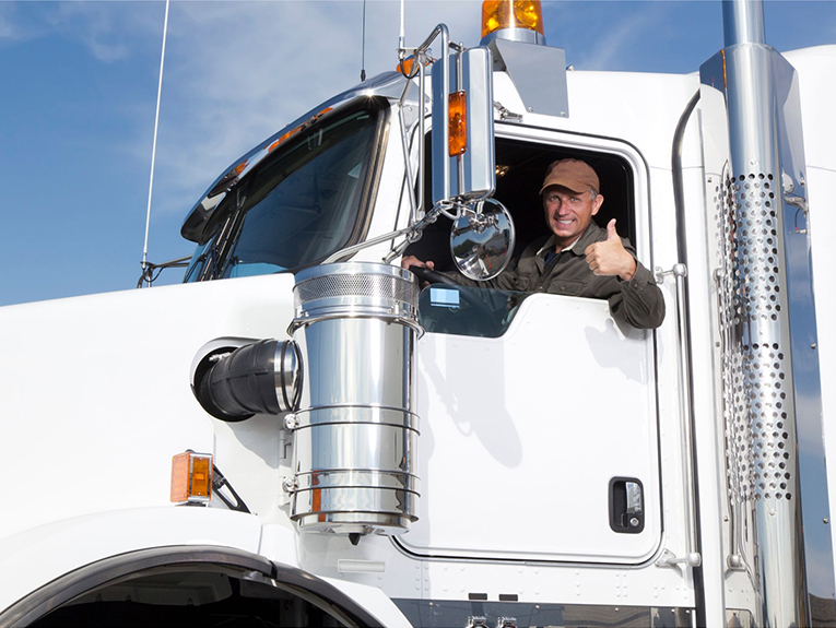 image of smiling driver giving thumbs up in a white truck