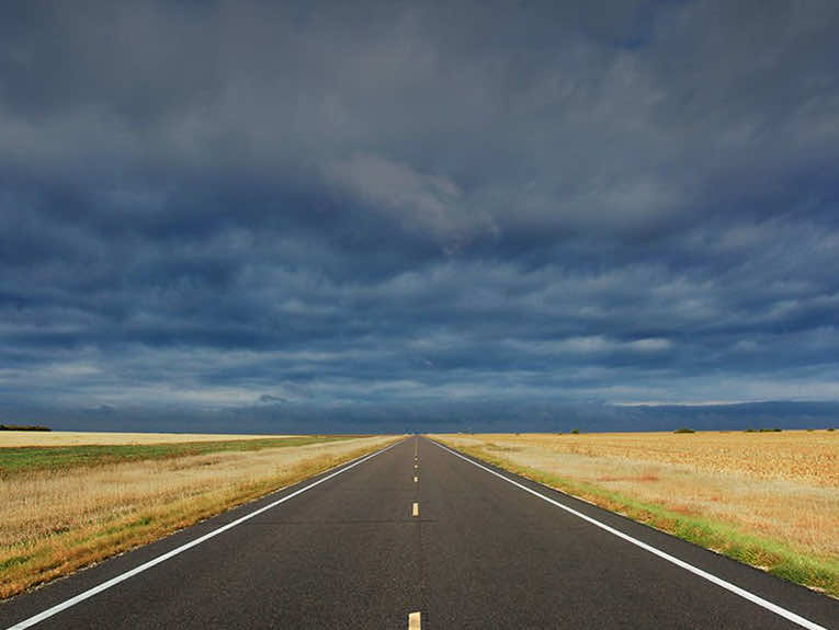 image of empty highway with storm in the sky