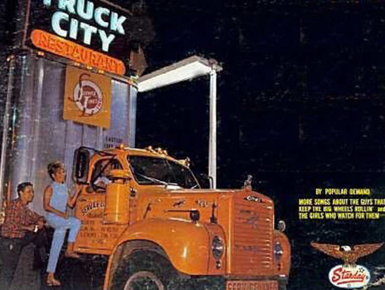 image of old orange truck with truck city sign over it