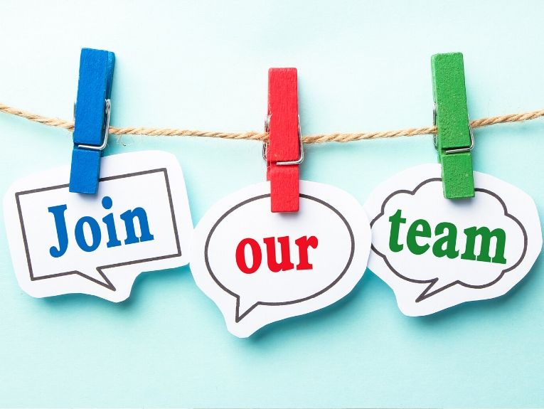 image of clothespins on a rope holding paper conversation bubbles with text that reads "Join our team"