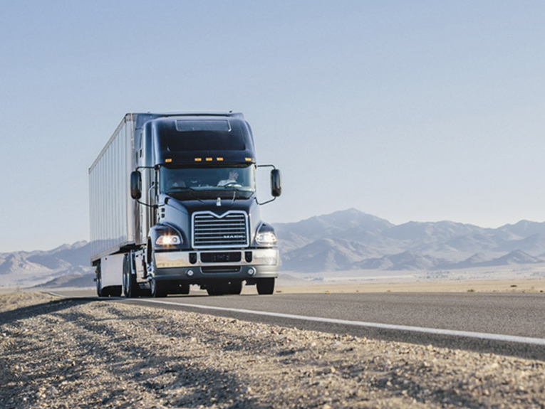 image of truck driving on desert highway