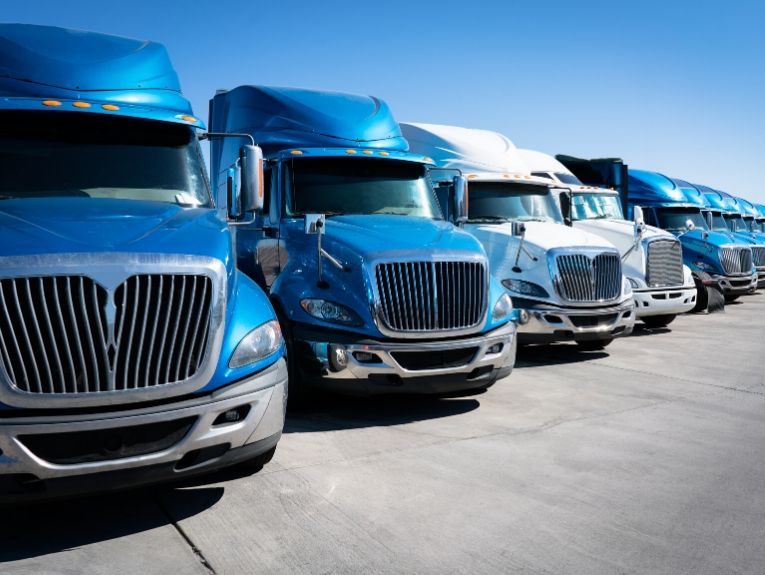 image of blue and white semi trucks parked side by side