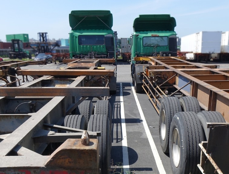 Two chassis trucks parked