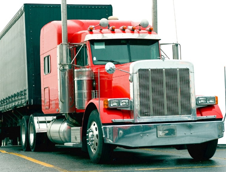 Red semi truck on an open road