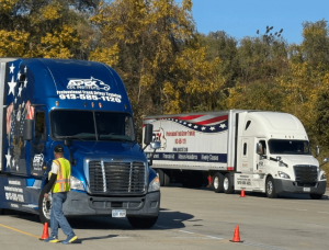Two Apex semi trucks parked on the training yard