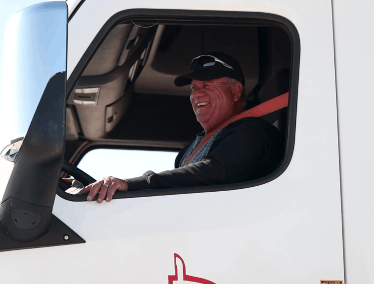Closeup of a trucker inside Apex truck cab
